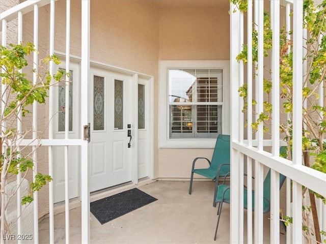 entrance to property with stucco siding