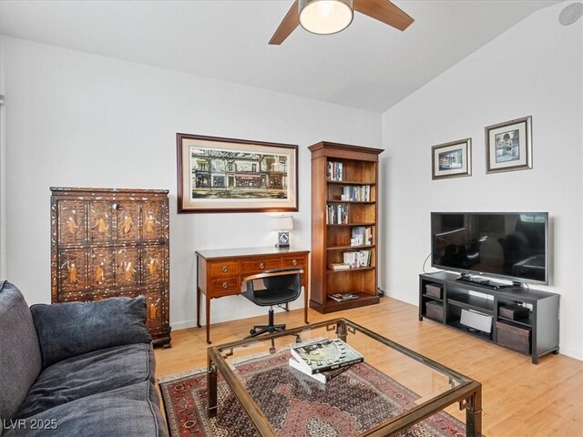 living room featuring lofted ceiling, wood finished floors, and a ceiling fan