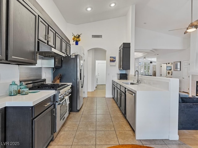 kitchen featuring visible vents, ceiling fan, under cabinet range hood, stainless steel appliances, and a sink