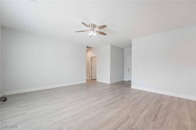 empty room with baseboards, a ceiling fan, and light wood finished floors