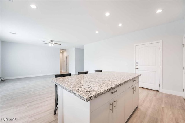 kitchen with visible vents, a center island, ceiling fan, recessed lighting, and light wood-style floors