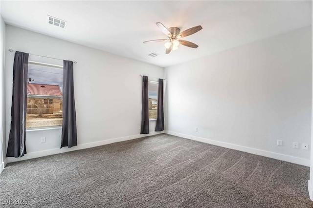 spare room featuring carpet flooring, visible vents, baseboards, and a ceiling fan