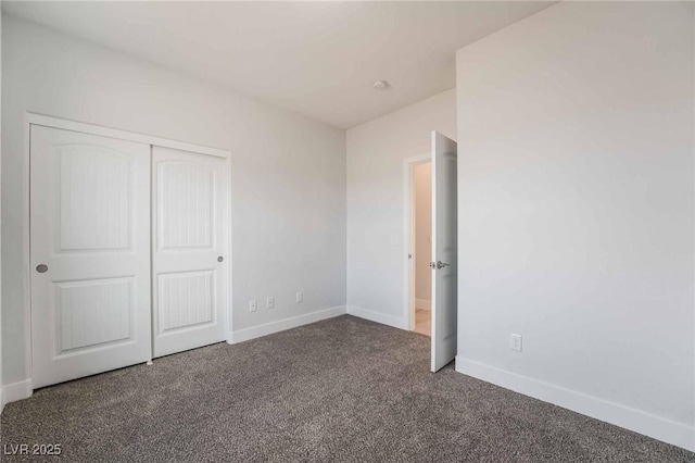 unfurnished bedroom featuring a closet, baseboards, and carpet floors