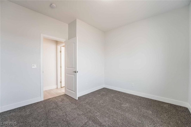 unfurnished room featuring baseboards and carpet flooring