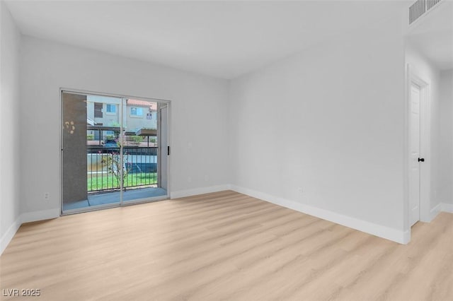 empty room with visible vents, baseboards, and light wood-style flooring