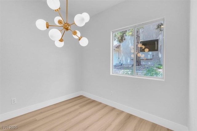 unfurnished dining area with a notable chandelier, plenty of natural light, and wood finished floors