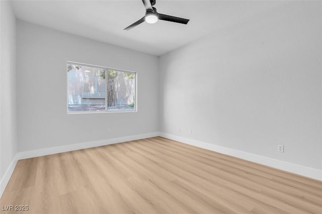 spare room with a ceiling fan, baseboards, and light wood finished floors