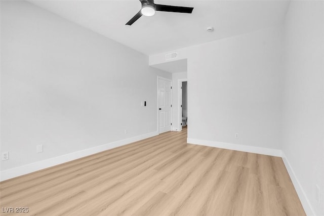 empty room featuring visible vents, a ceiling fan, baseboards, and wood finished floors