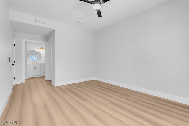 unfurnished room featuring ceiling fan, visible vents, baseboards, and light wood-style flooring