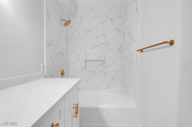 bathroom featuring shower / tub combination and vanity