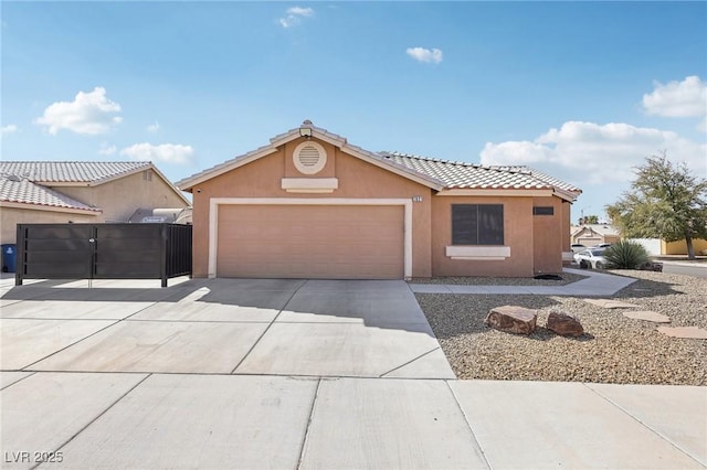 view of front facade with fence, driveway, stucco siding, a garage, and a tile roof