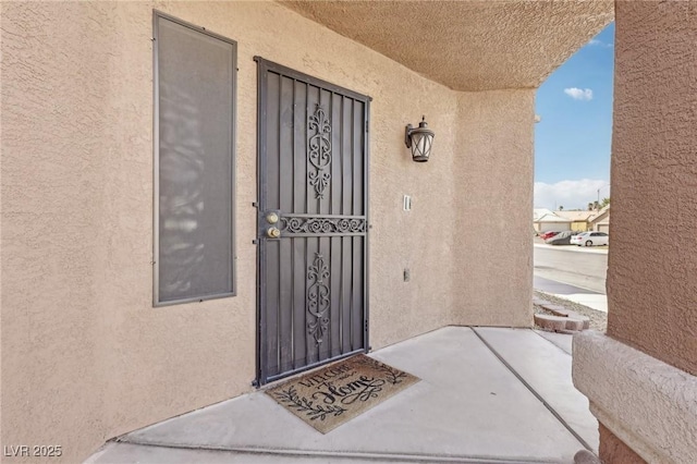 doorway to property with stucco siding