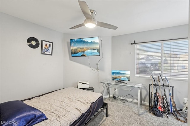 carpeted bedroom featuring baseboards and ceiling fan