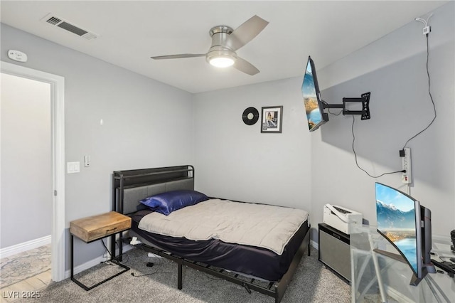 bedroom with baseboards, visible vents, and ceiling fan