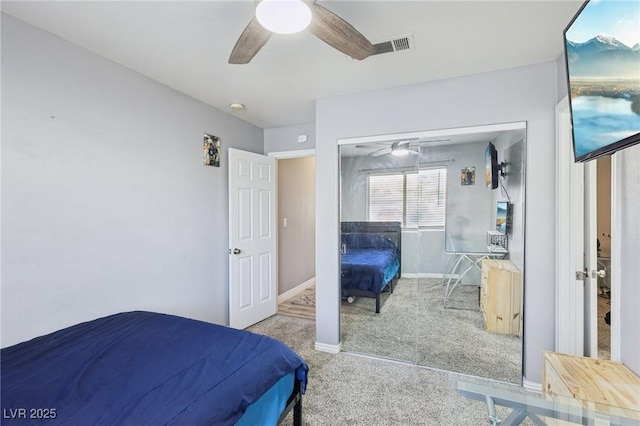 carpeted bedroom with visible vents, a ceiling fan, and baseboards