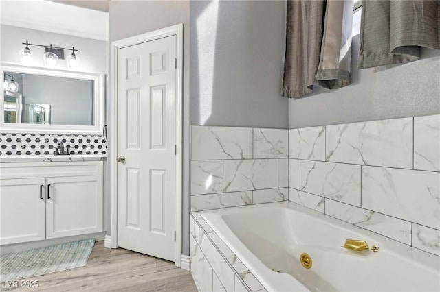 bathroom featuring wood finished floors and a whirlpool tub