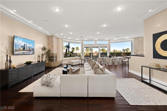 living area with wood finished floors, recessed lighting, and a healthy amount of sunlight