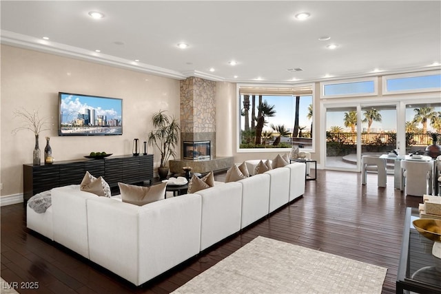 living room featuring dark wood finished floors, recessed lighting, baseboards, and a premium fireplace