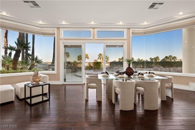 interior space featuring visible vents, plenty of natural light, and dark wood-type flooring