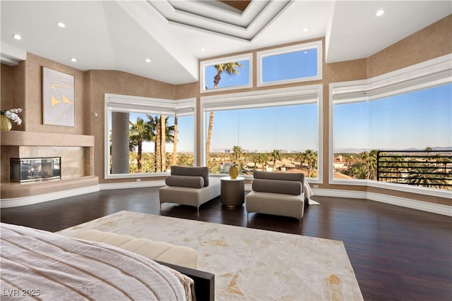 bedroom with dark wood finished floors, recessed lighting, a fireplace, and baseboards