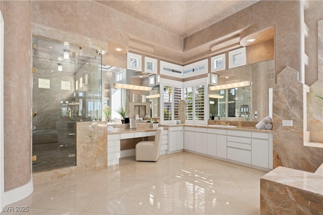 full bath with vanity and a shower stall