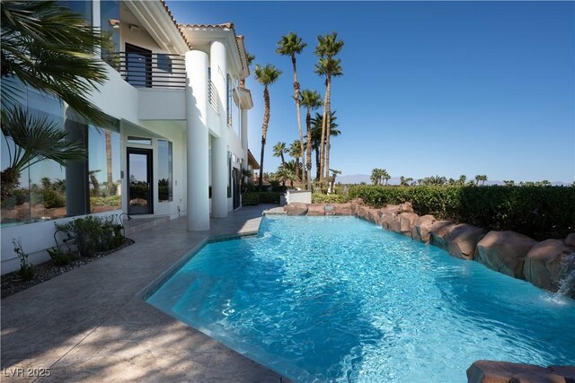 view of swimming pool featuring a fenced in pool and a patio