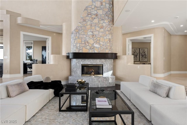 living room with recessed lighting, a fireplace, and baseboards