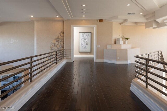 corridor with wood finished floors, visible vents, baseboards, recessed lighting, and an upstairs landing