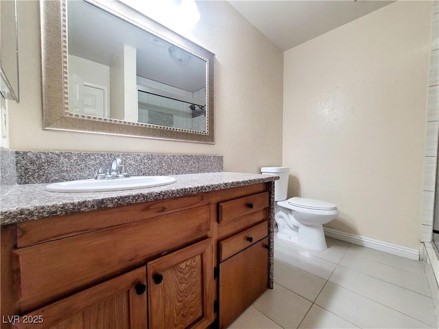 bathroom featuring vanity, baseboards, a shower, tile patterned floors, and toilet