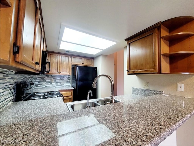 kitchen featuring black appliances, open shelves, a sink, tasteful backsplash, and a peninsula