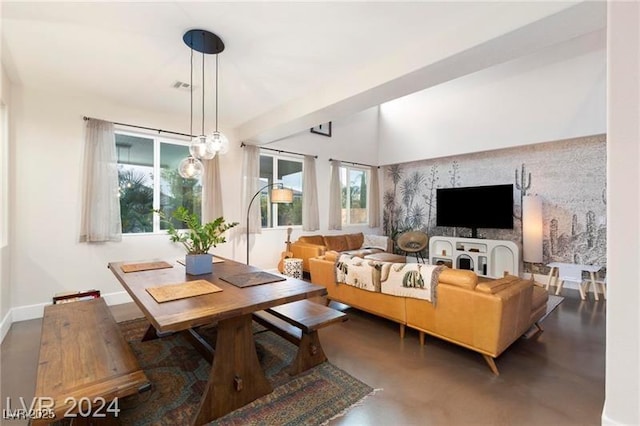 living area with visible vents, baseboards, and concrete flooring