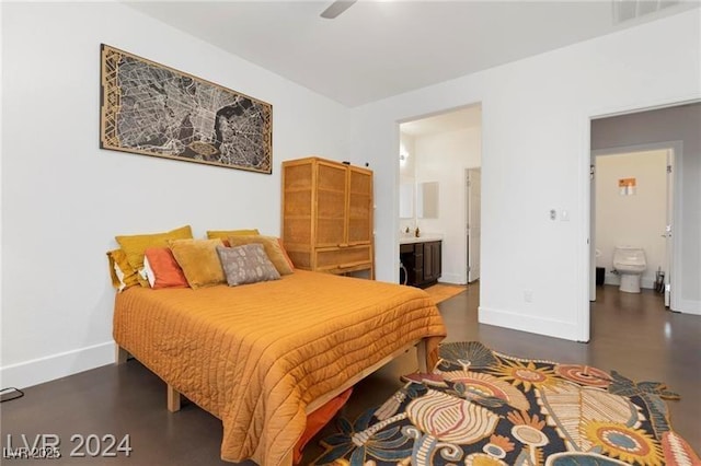 bedroom featuring a ceiling fan, baseboards, and connected bathroom