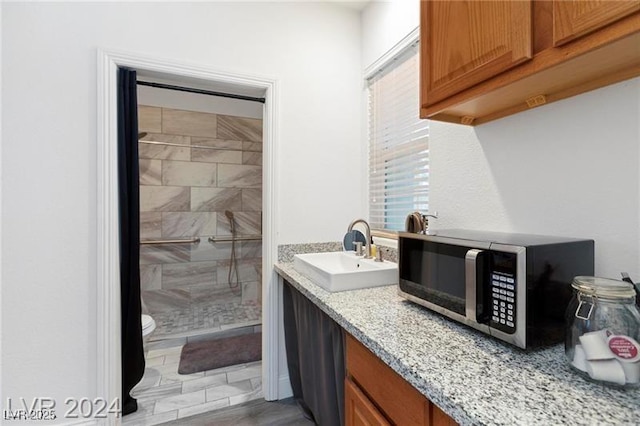 bathroom featuring vanity, a shower stall, and toilet