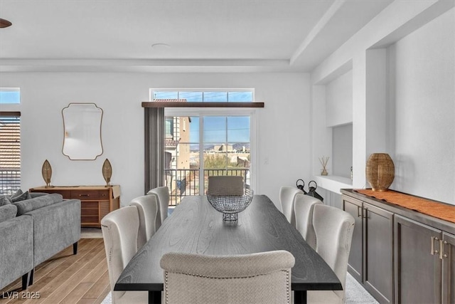 dining space featuring plenty of natural light and light wood-style floors