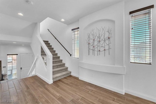 foyer entrance featuring stairway, recessed lighting, baseboards, and wood finished floors