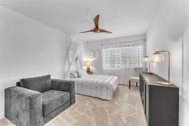 bedroom with a ceiling fan and light carpet