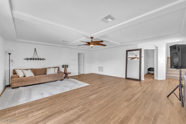 living room with visible vents, ceiling fan, and light wood-style floors