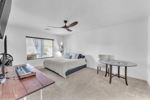 carpeted bedroom with visible vents, baseboards, and a ceiling fan