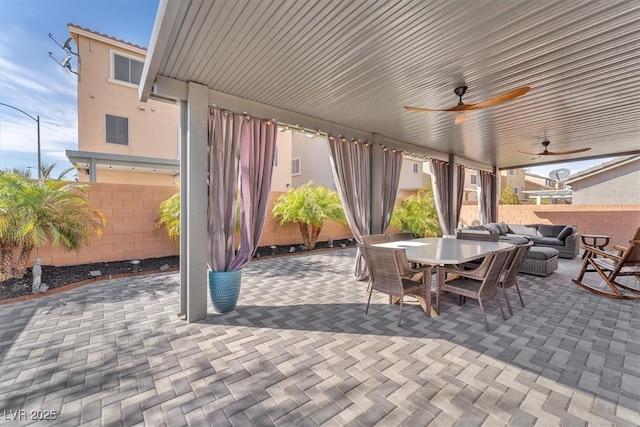 view of patio / terrace with an outdoor hangout area, outdoor dining space, a ceiling fan, and fence