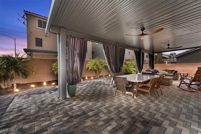 view of patio featuring an outdoor hangout area, outdoor dining area, ceiling fan, and fence