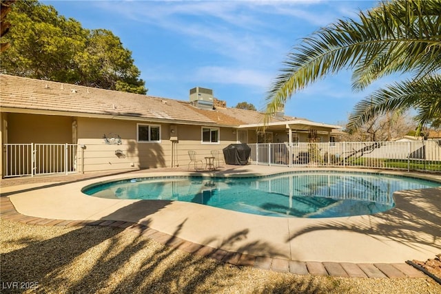 view of swimming pool featuring a patio area, a fenced in pool, a grill, and fence