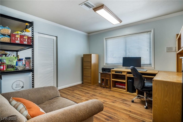 home office with visible vents, ornamental molding, baseboards, and wood finished floors