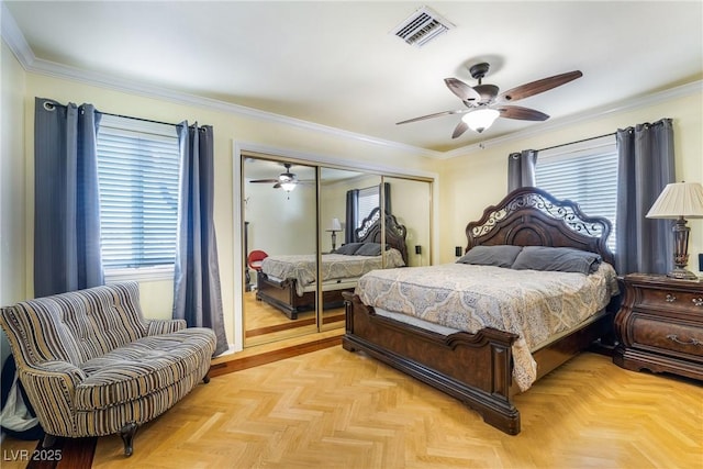 bedroom featuring a closet, visible vents, crown molding, and ceiling fan