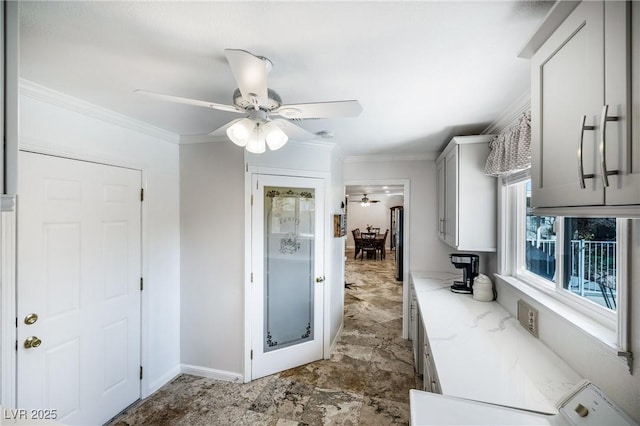 bathroom with a shower stall, baseboards, a ceiling fan, and ornamental molding