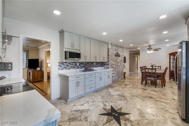 kitchen with gray cabinets, a ceiling fan, backsplash, recessed lighting, and stainless steel appliances