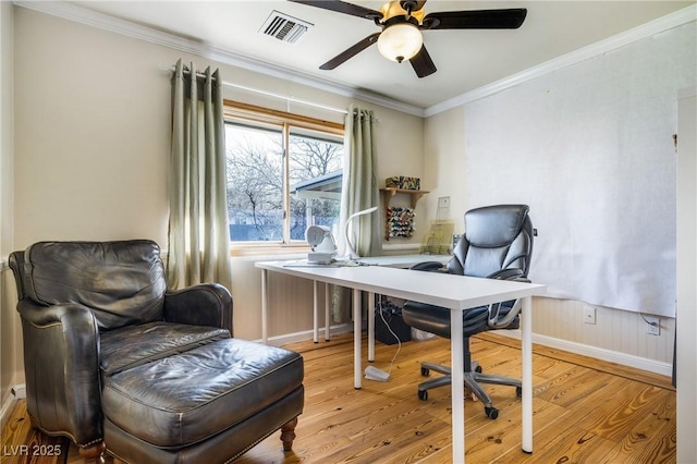 office space with visible vents, crown molding, a ceiling fan, and wood finished floors