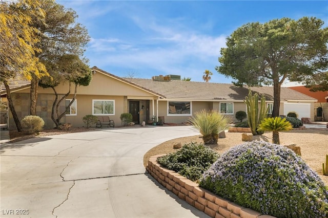 single story home featuring concrete driveway