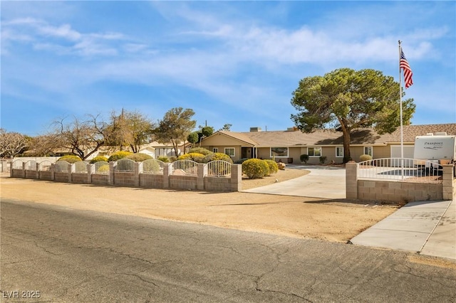 view of front of home with a fenced front yard and a gate