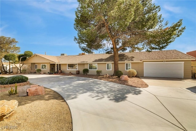 ranch-style house with concrete driveway and an attached garage