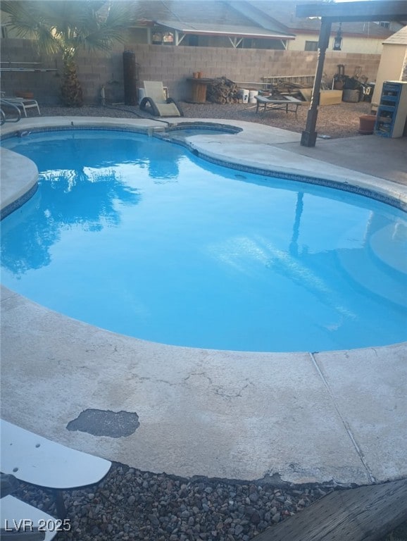 view of pool featuring a patio, a fenced in pool, and fence